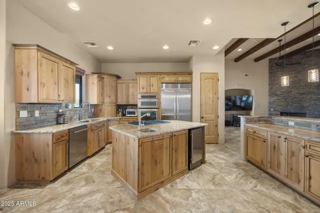 a kitchen with stainless steel appliances granite countertop a sink and cabinets