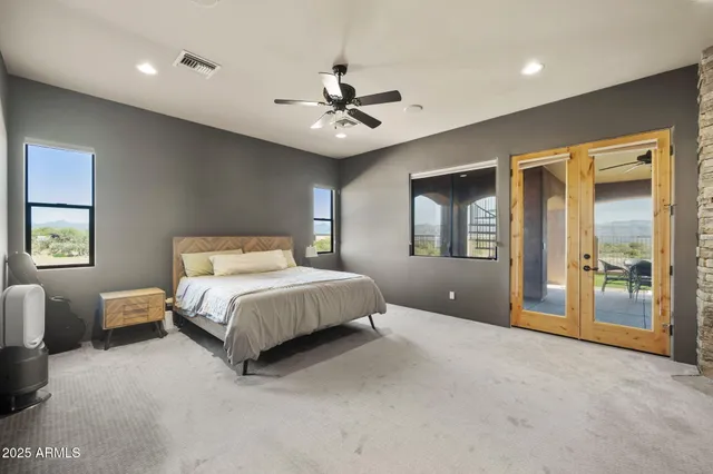 a spacious bedroom with a bed and a chandelier