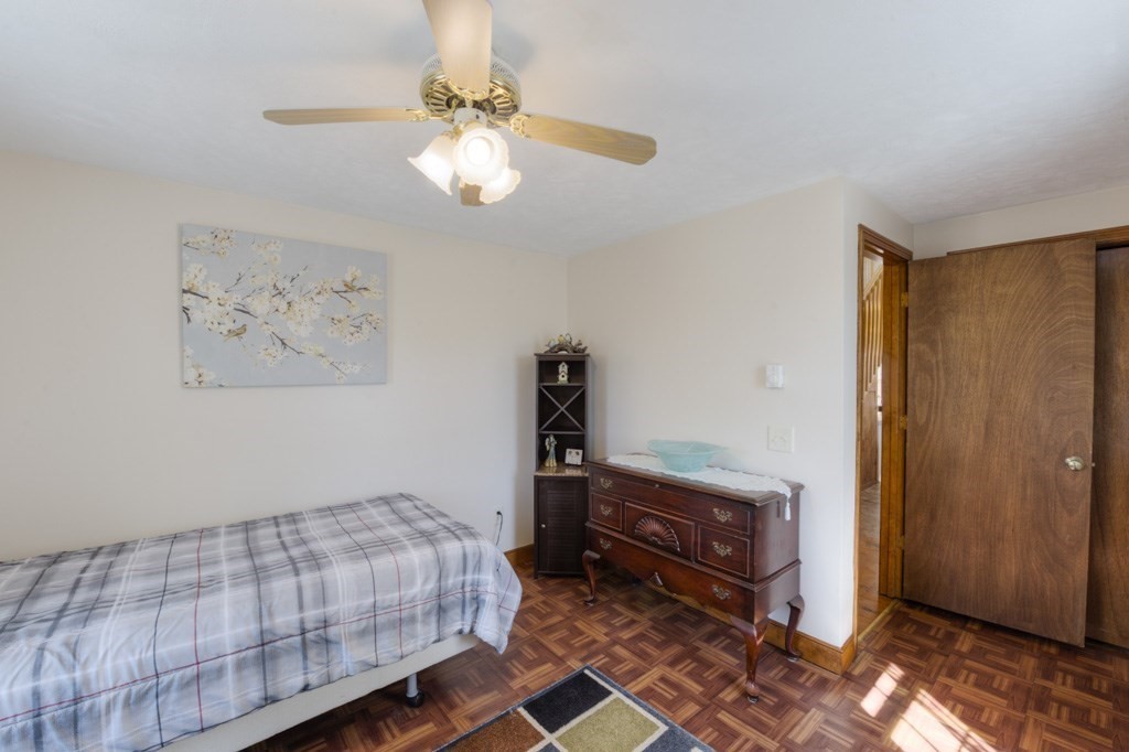 51 Webber Road Brookfield, MA 01506 - Photo 14 of 42 a bedroom with a bed and a chandelier