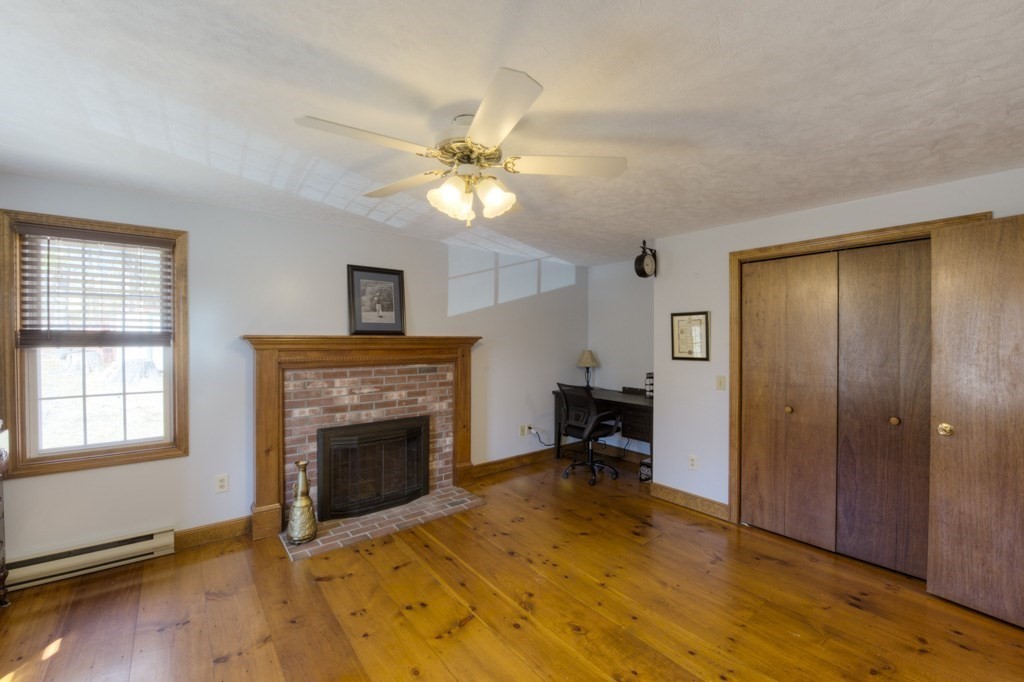 51 Webber Road Brookfield, MA 01506 - Photo 18 of 42 a view of an empty room with a fireplace and a window