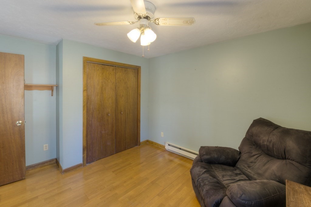 51 Webber Road Brookfield, MA 01506 - Photo 22 of 42 a bedroom with a bed couch and a ceiling fan