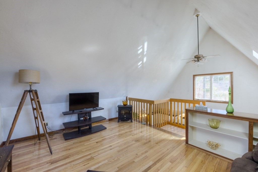 51 Webber Road Brookfield, MA 01506 - Photo 25 of 42 a living room with furniture a flat screen tv and a wooden floor