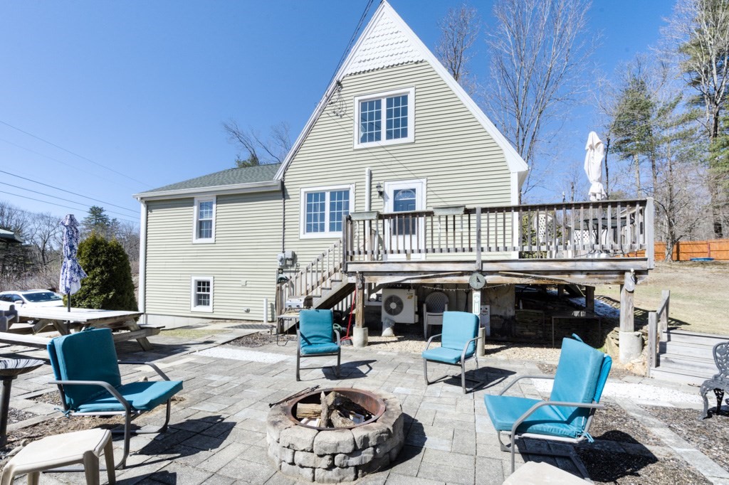 51 Webber Road Brookfield, MA 01506 - Photo 4 of 42 a table and chairs in front of a house