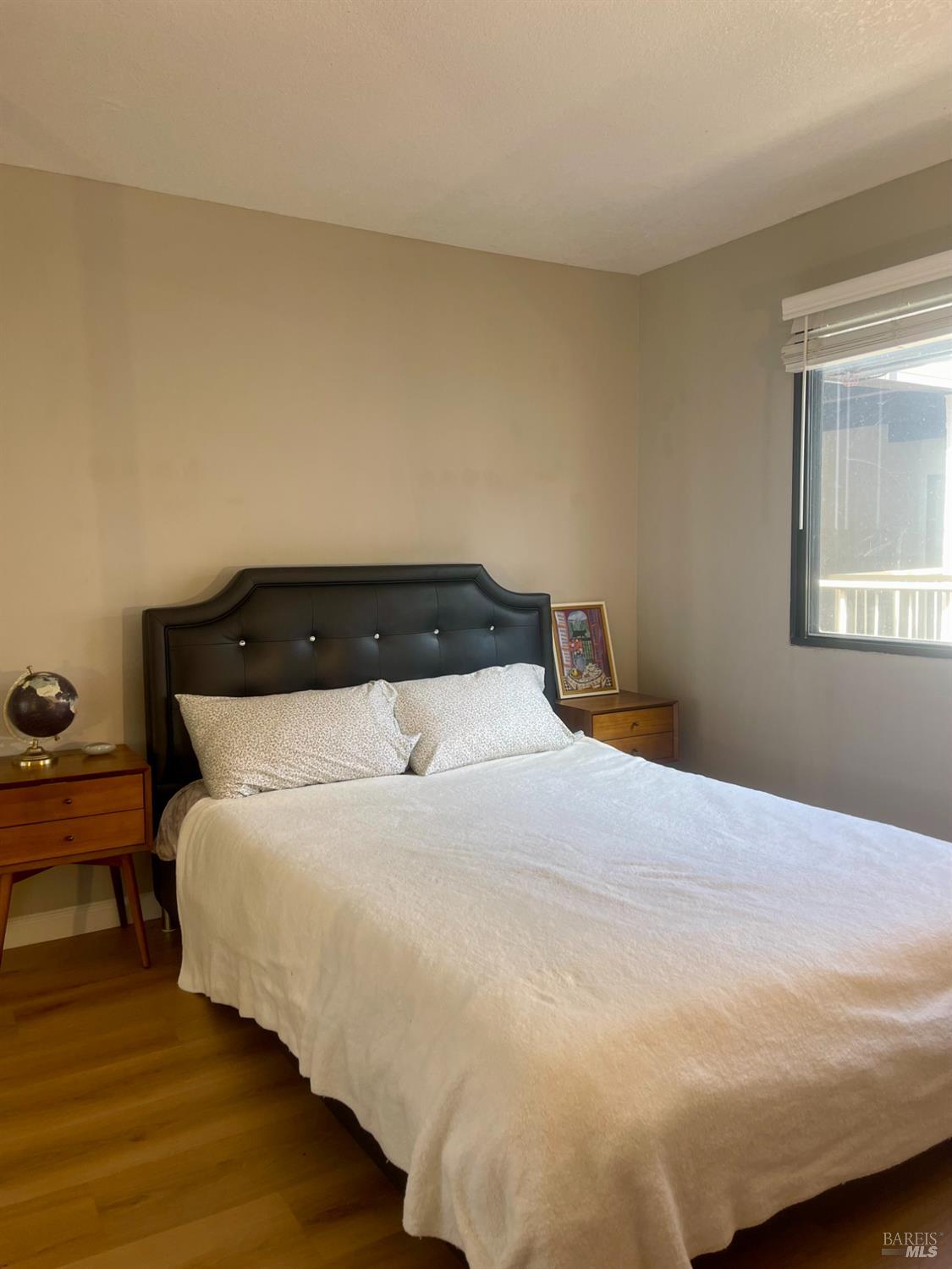 1 Embarcadero West, Unit 355 Oakland, CA 94607 - Photo 14 of 20 a bedroom with a bed and wooden floor