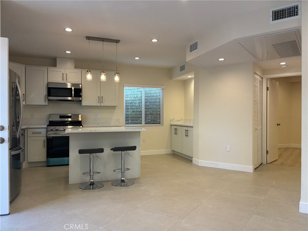 9353 Crystal View Drive Tujunga, CA 91042 - Photo 2 of 8 a kitchen with stainless steel appliances a refrigerator sink and stove