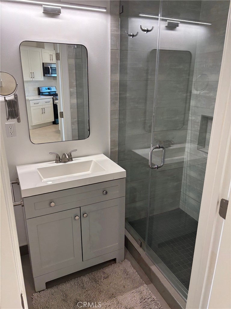 9353 Crystal View Drive Tujunga, CA 91042 - Photo 6 of 8 a bathroom with a shower sink and mirror