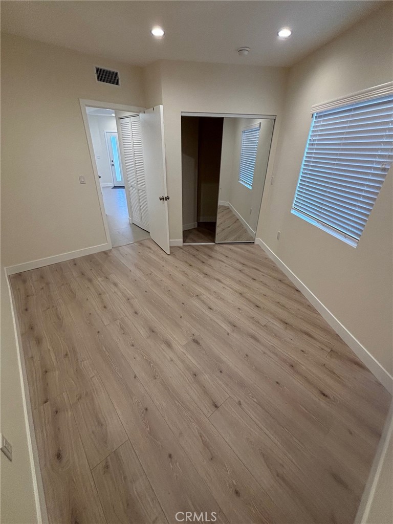 9353 Crystal View Drive Tujunga, CA 91042 - Photo 7 of 8 an empty room with wooden floor and closet area