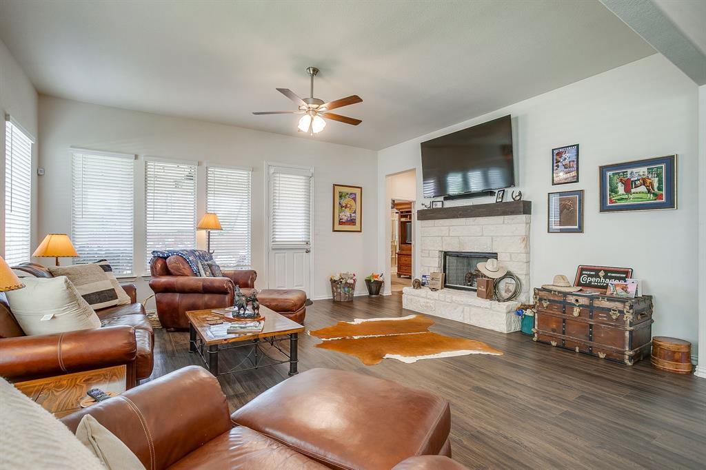 1328 San Marcus Drive Springtown, TX 76082 - Photo 18 of 37 a living room with furniture a flat screen tv and a fireplace