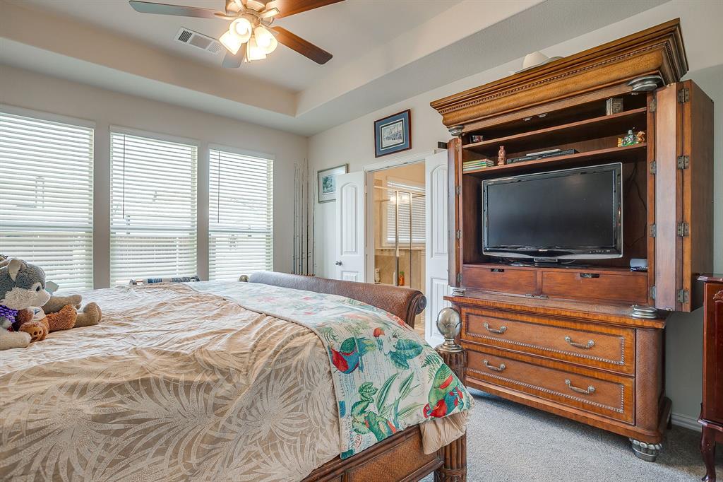 1328 San Marcus Drive Springtown, TX 76082 - Photo 19 of 37 a bedroom with a bed and a flat screen tv