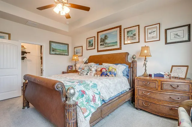 a bed sitting in a bedroom and a flat screen tv