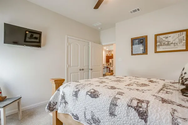 a bedroom with a bed and a flat screen tv