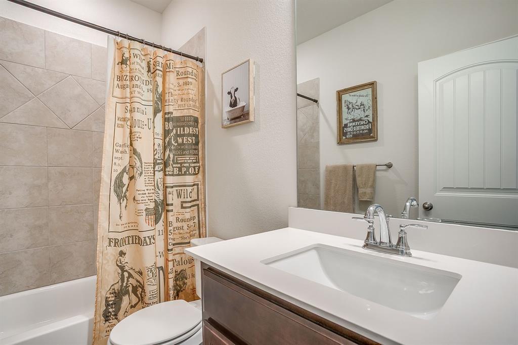 1328 San Marcus Drive Springtown, TX 76082 - Photo 29 of 37 a bathroom with a sink a toilet and shower curtain