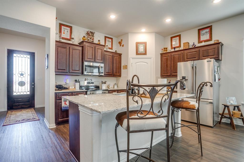 1328 San Marcus Drive Springtown, TX 76082 - Photo 7 of 37 a view of a kitchen with furniture and wooden floor
