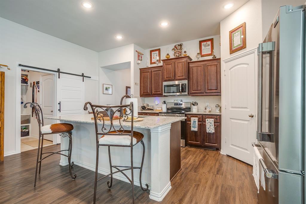 1328 San Marcus Drive Springtown, TX 76082 - Photo 8 of 37 a kitchen with stainless steel appliances a refrigerator and wooden floor