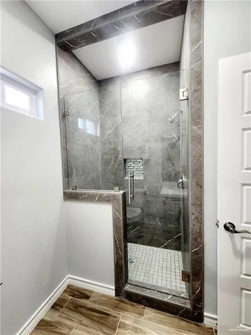 a bathroom with a glass shower door