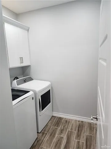 a view of storage and utility room with washer and dryer