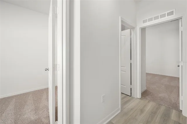a view of a room with wooden floor