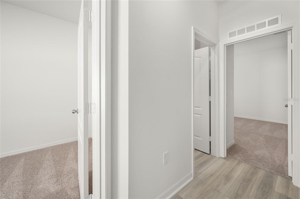 13284 Tula Loop Astatula, FL 34705 - Photo 13 of 24 a view of a room with wooden floor