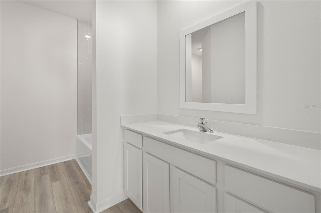 13284 Tula Loop Astatula, FL 34705 - Photo 21 of 24 a bathroom with a sink and a mirror