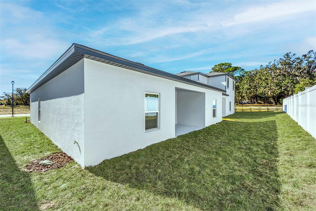 13284 Tula Loop Astatula, FL 34705 - Photo 23 of 24 a view of a house with a yard
