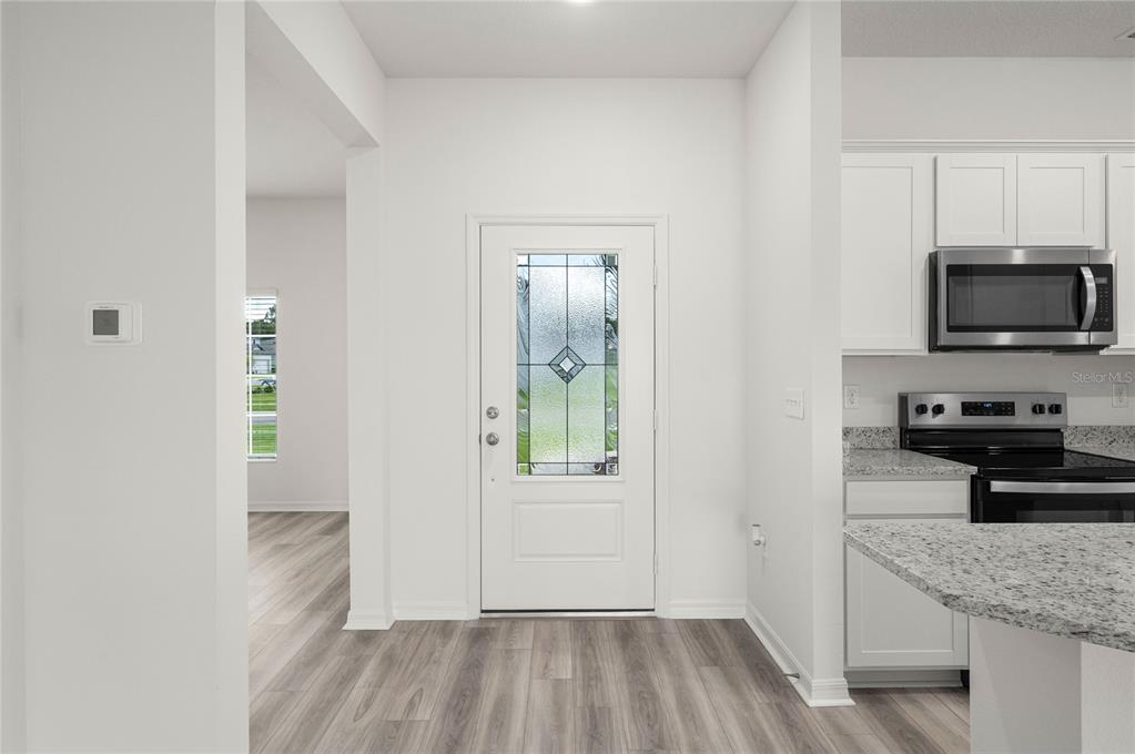 13284 Tula Loop Astatula, FL 34705 - Photo 6 of 24 a kitchen with a refrigerator and a stove top oven