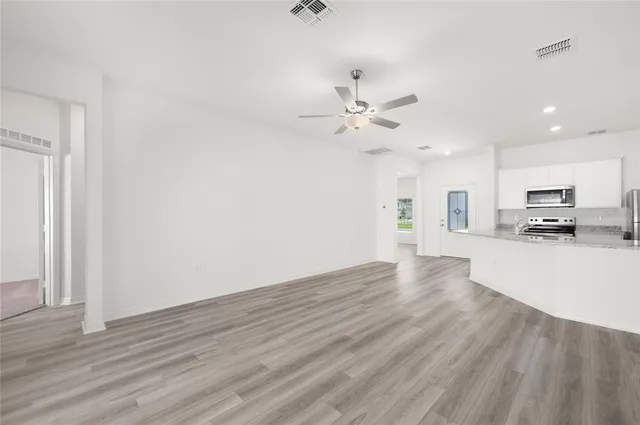 a view of a kitchen with a sink and a stove top oven