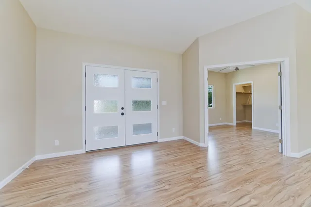 wooden floor in an empty room with a window