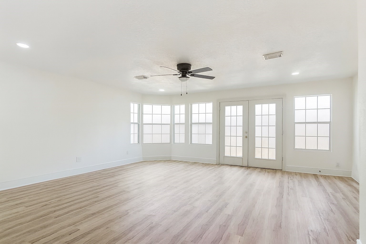 13123 Labelle Lane Houston, TX 77015 - Photo 11 of 23 an empty room with wooden floor and windows