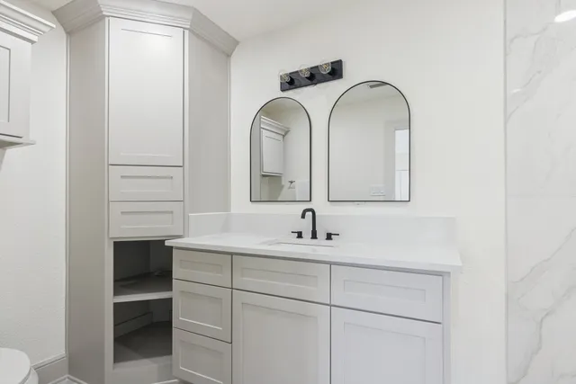 a bathroom with a double vanity sink and a