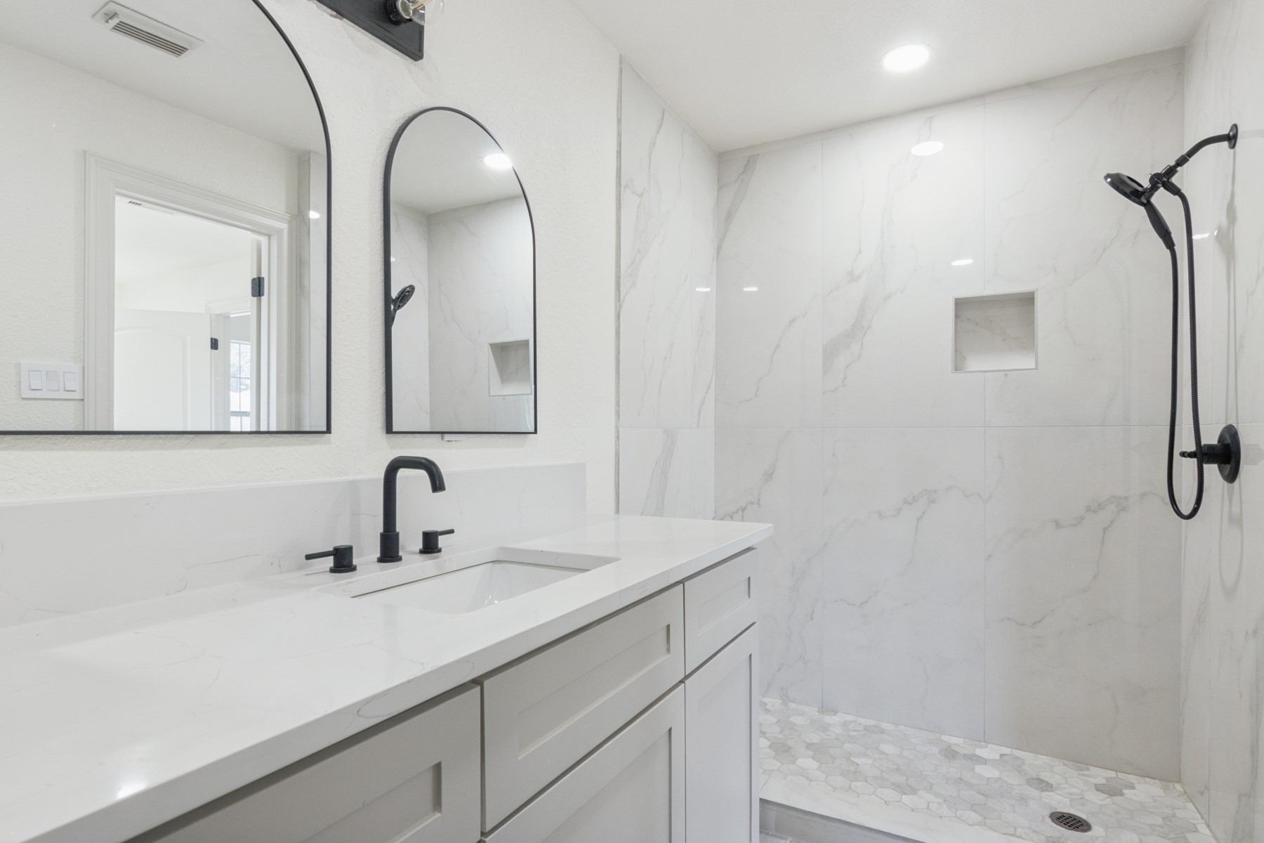 13123 Labelle Lane Houston, TX 77015 - Photo 13 of 23 a bathroom with a sink a mirror a vanity and shower