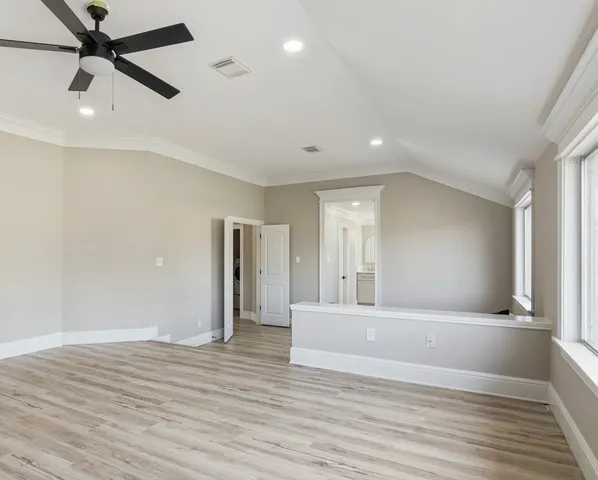 a view of a livingroom with wooden floor and a ceiling fan