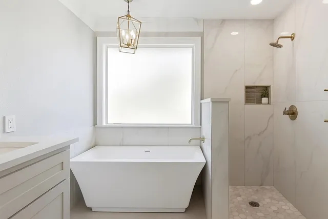 a bathroom with a bathtub and shower