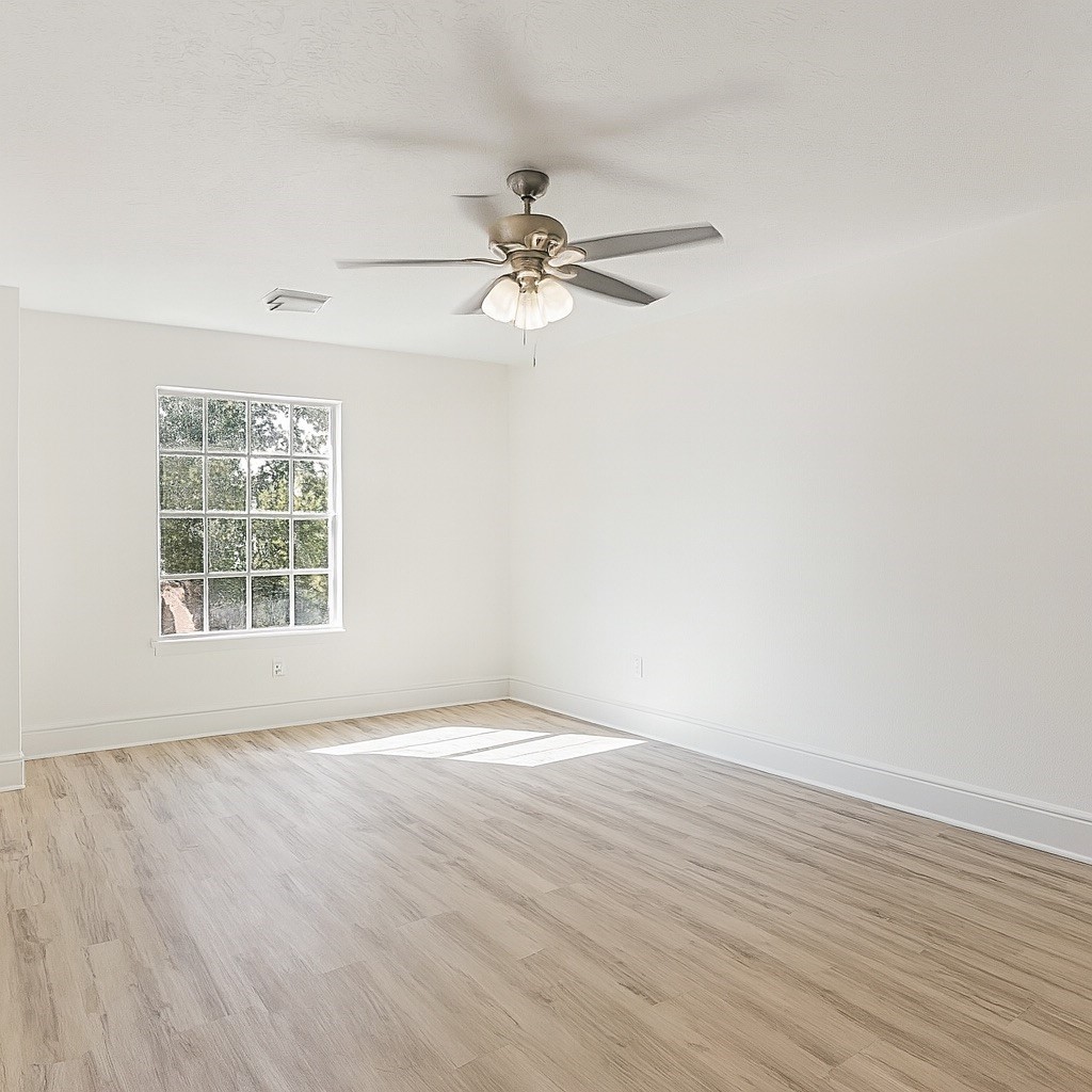 13123 Labelle Lane Houston, TX 77015 - Photo 20 of 23 an empty room with wooden floor fan and windows