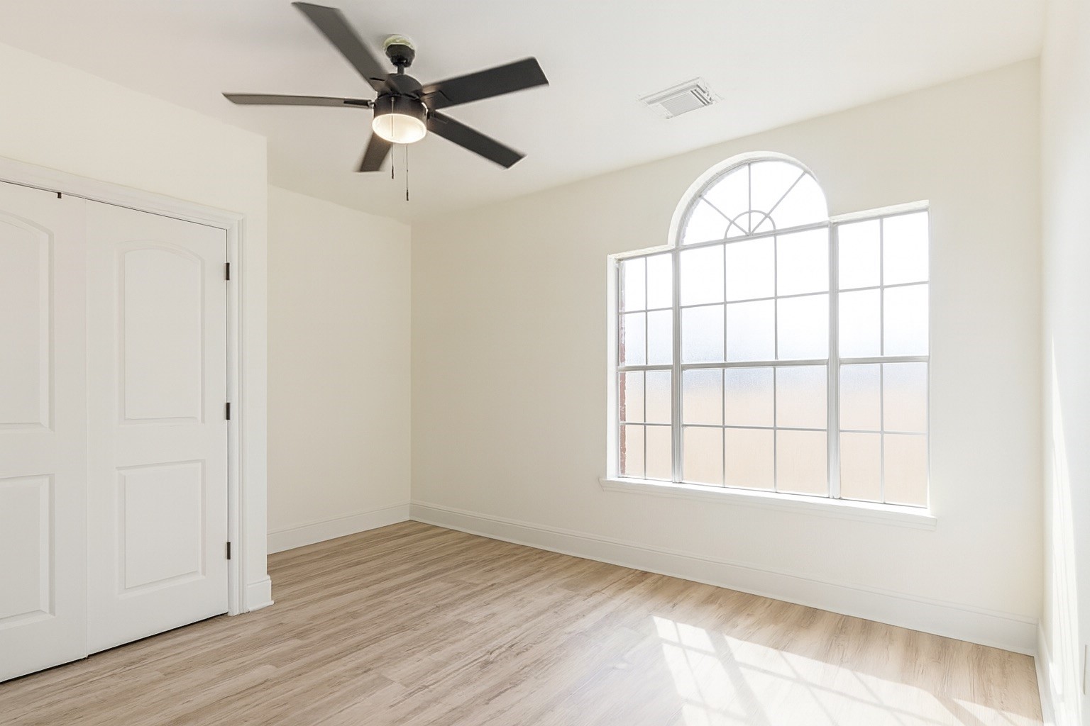 13123 Labelle Lane Houston, TX 77015 - Photo 21 of 23 an empty room with wooden floor fan and windows