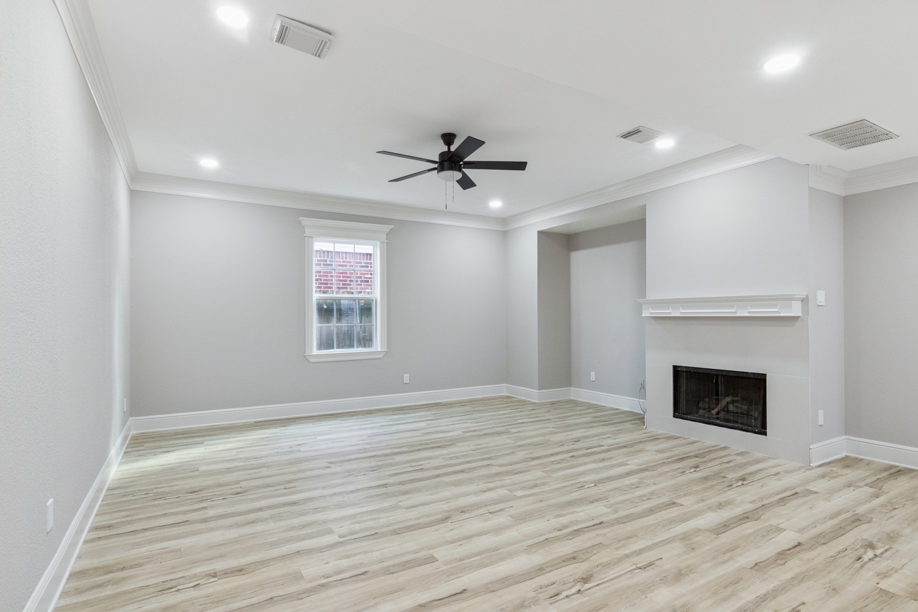 13123 Labelle Lane Houston, TX 77015 - Photo 6 of 23 a view of an empty room with a fireplace and a window