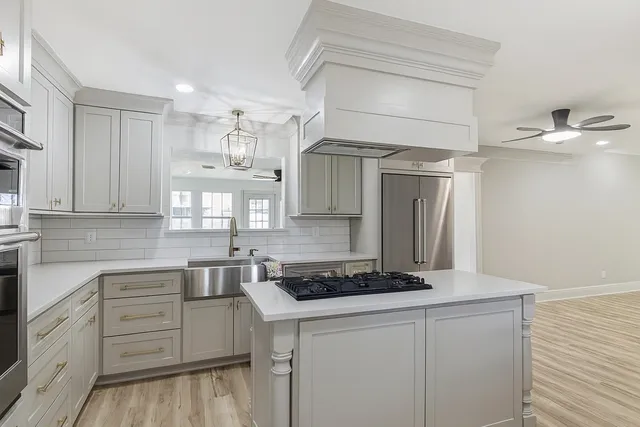 a kitchen with cabinets appliances and a counter space