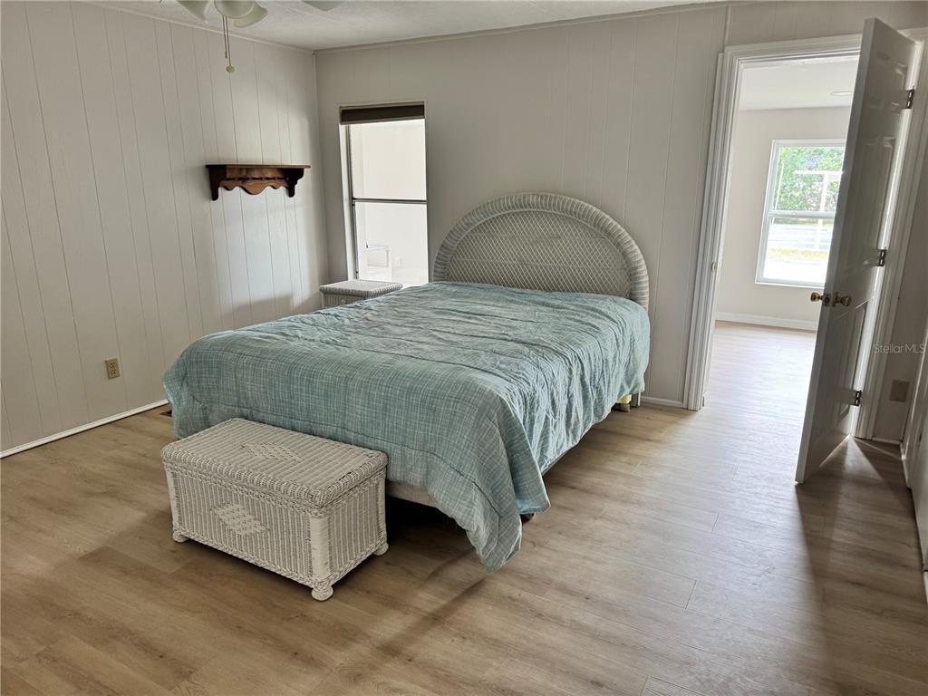 1891 Englewood Road, Unit 45 Englewood, FL 34223 - Photo 24 of 55 a bedroom with a bed and a mirror