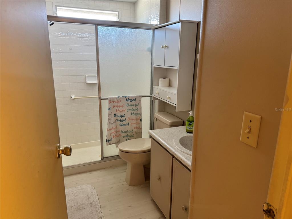 1891 Englewood Road, Unit 45 Englewood, FL 34223 - Photo 25 of 55 a bathroom with a sink a toilet and shower