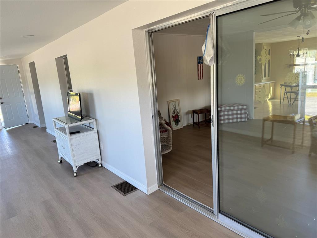 1891 Englewood Road, Unit 45 Englewood, FL 34223 - Photo 28 of 55 a view of a hallway with a living room