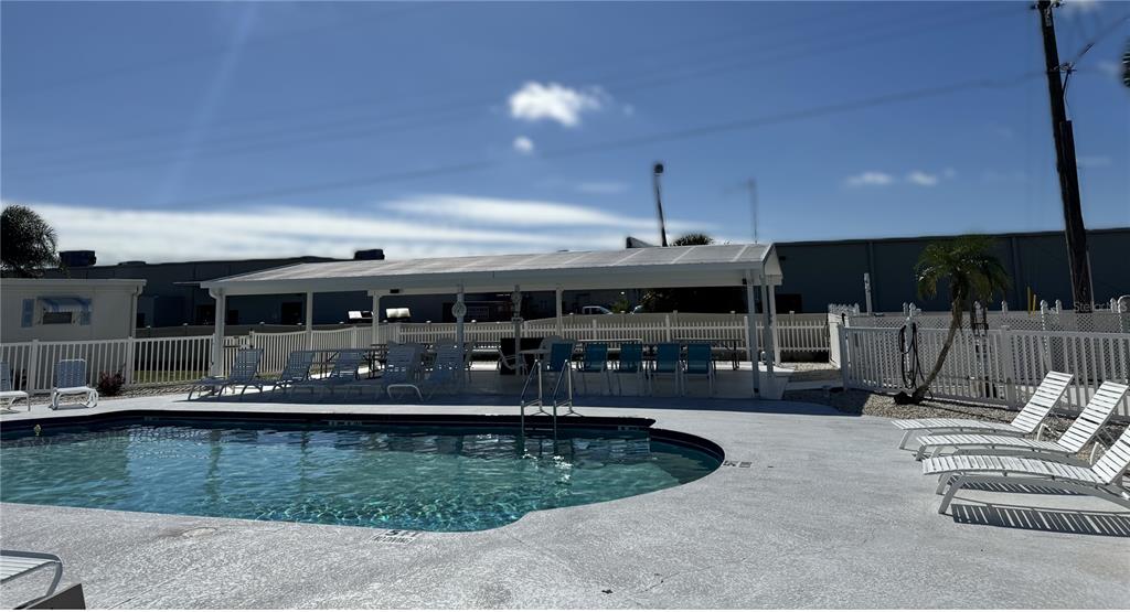 1891 Englewood Road, Unit 45 Englewood, FL 34223 - Photo 5 of 55 a view of a swimming pool with chairs
