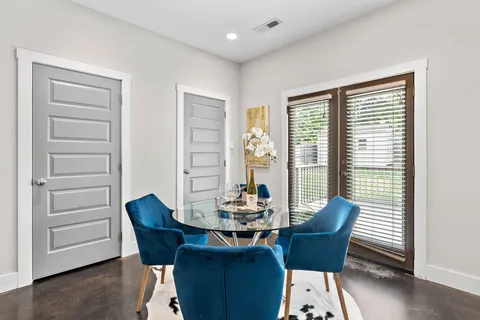 a dining room with furniture and window
