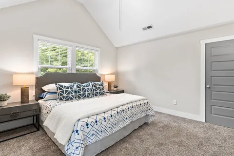 a bedroom with a bed and a window