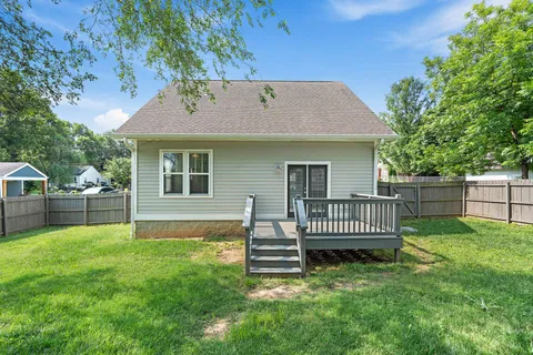 a view of a house with a yard and a garden