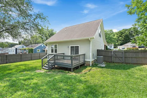 a front view of a house with a yard and fence
