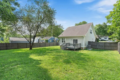 a view of a house with a yard and sitting area