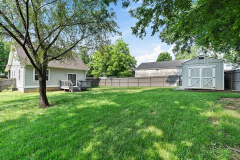 a view of a house with a backyard