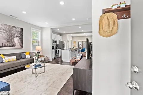 a living room with furniture and a wooden floor