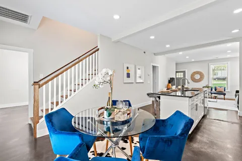a living room with furniture and kitchen view