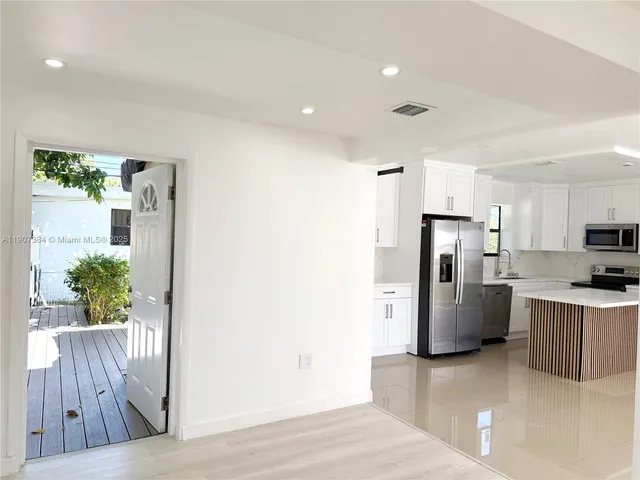 a kitchen with a refrigerator and a microwave