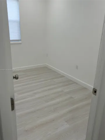 a view of a small space with wooden floor
